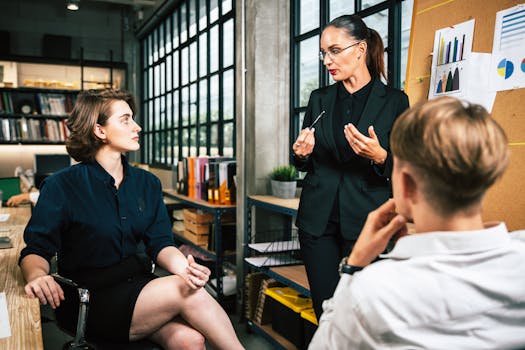 Three colleagues engage in a vibrant business meeting in a modern office setting.